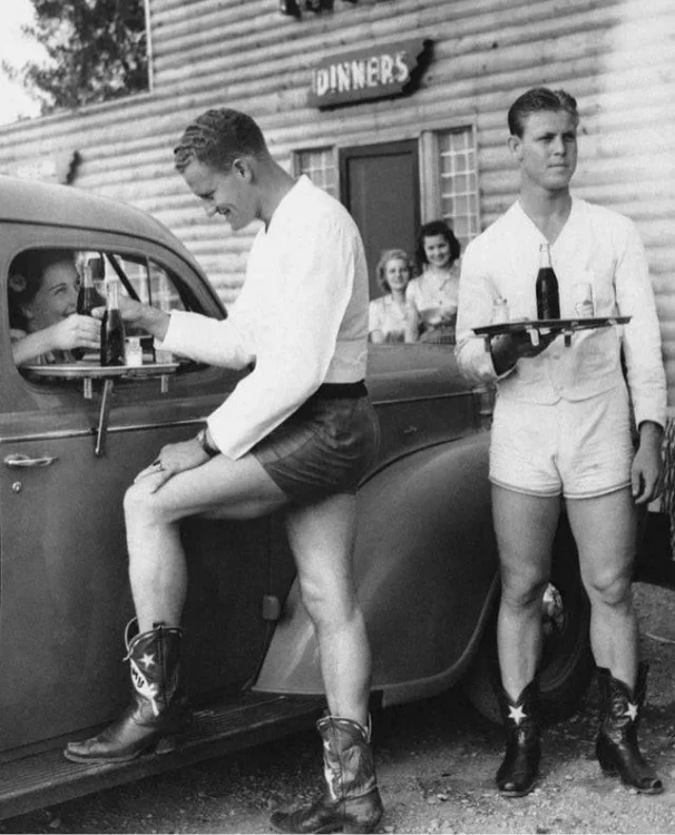 men-waiters-in-shorts-and-cowboy-boots-serve-women-at-the-v0-gkrcrpr7q2ea1.jpg